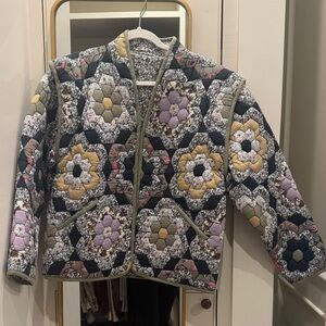 Patchwork jacket. Can unzip at shoulder to make a vest. Reversible.